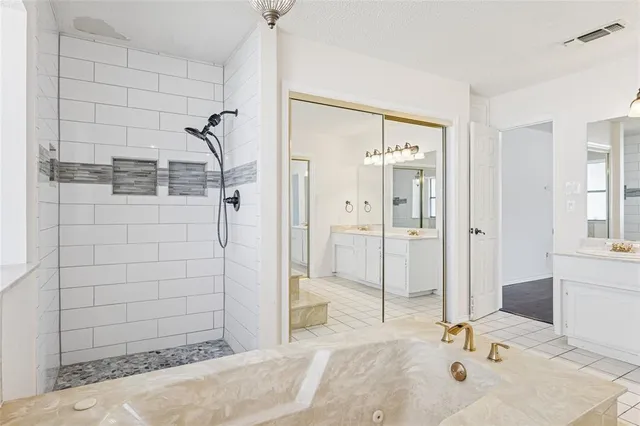 a bathroom with a tub shower and sink