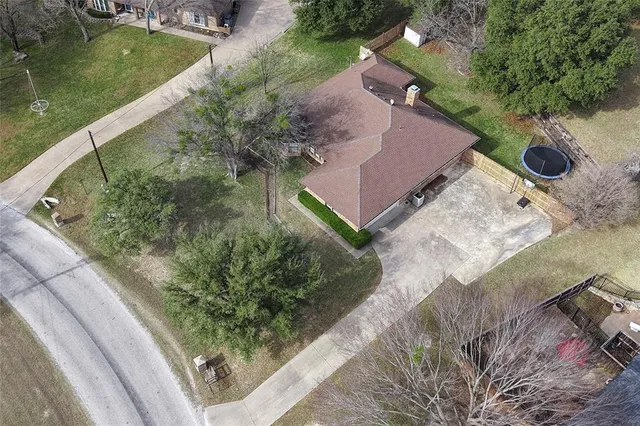 an aerial view of a house with garden space and street view