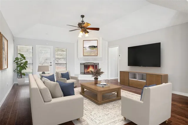 a living room with fireplace furniture and a flat screen tv