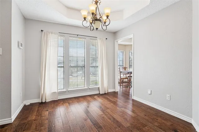 a view of a livingroom with wooden floor and a large window
