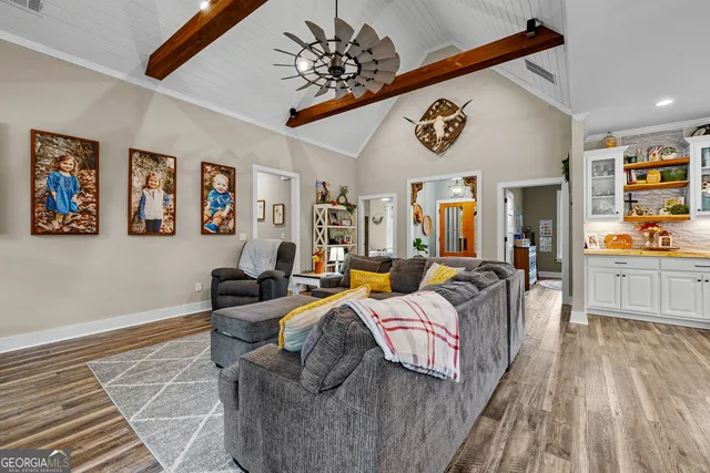 a large kitchen with stainless steel appliances kitchen island granite countertop a large stove a sink dishwasher and cabinets with wooden floor