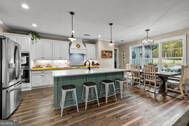 a view of a dining room with furniture a chandelier and wooden floor