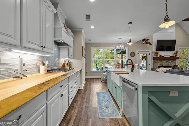 a bathroom with a granite countertop sink a toilet and shower