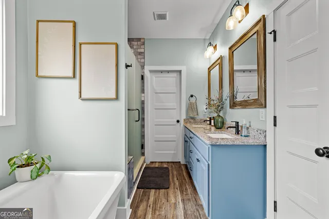 a bathroom with a granite countertop toilet sink and mirror