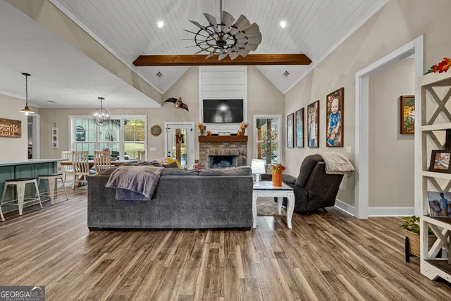a kitchen with granite countertop a table chairs stove a refrigerator and cabinets