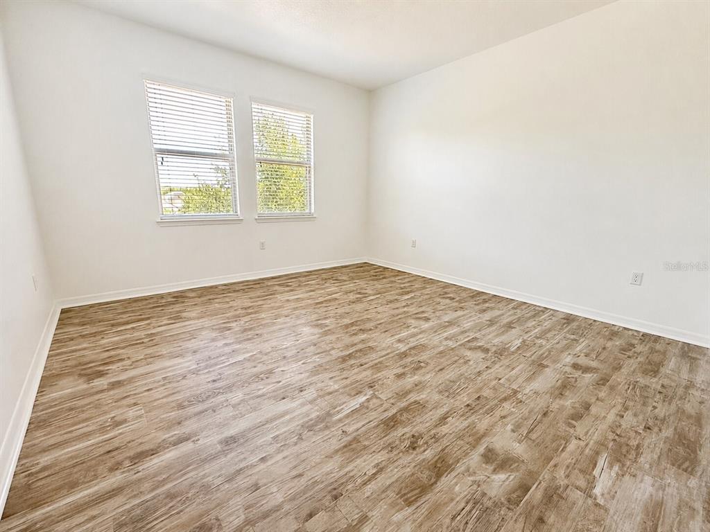 8531 Geddes Loop Orlando, FL 32836 - Photo 12 of 20 an empty room with wooden floor and a window