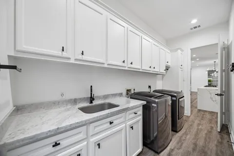 a kitchen with stainless steel appliances granite countertop a sink a stove and cabinets