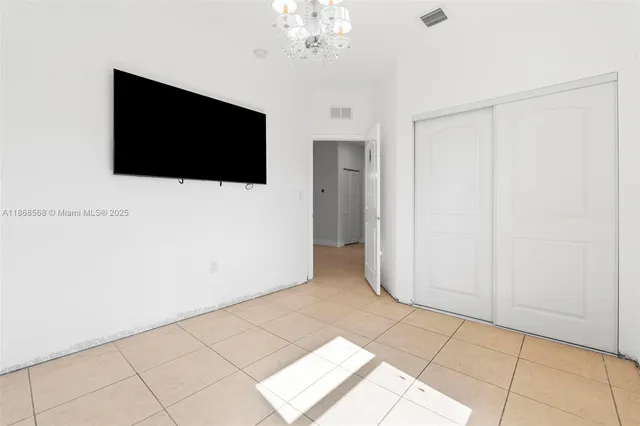 a living room with a large mirror and a flat screen tv