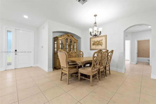 a view of a dining room with furniture and chandelier