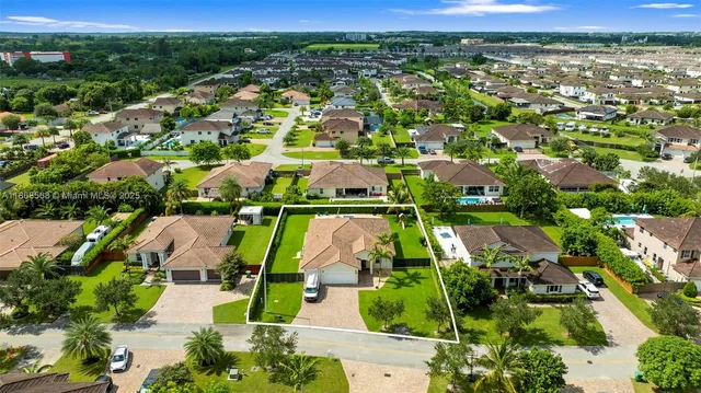 an aerial view of residential houses with outdoor space