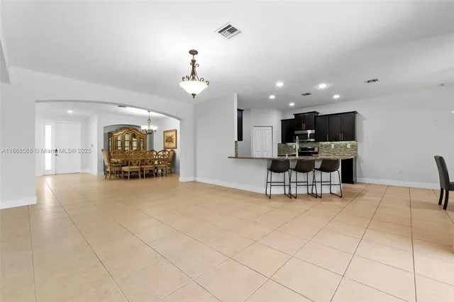 a view of kitchen with furniture and a refrigerator
