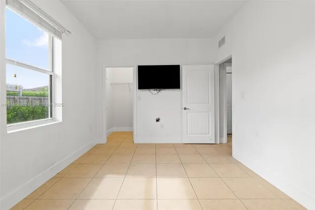 a view of a livingroom with an empty space and a window