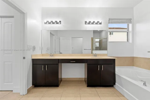 a bathroom with a sink double vanity and a bathtub