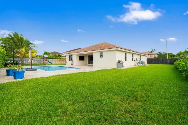 a view of outdoor kitchen with green space