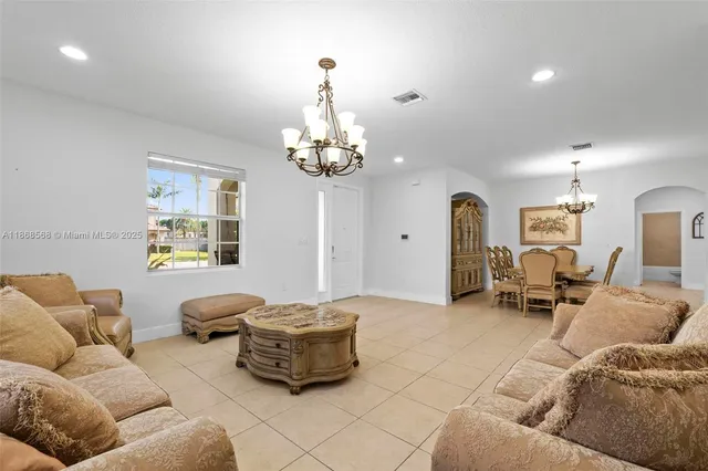 a living room with furniture and a chandelier