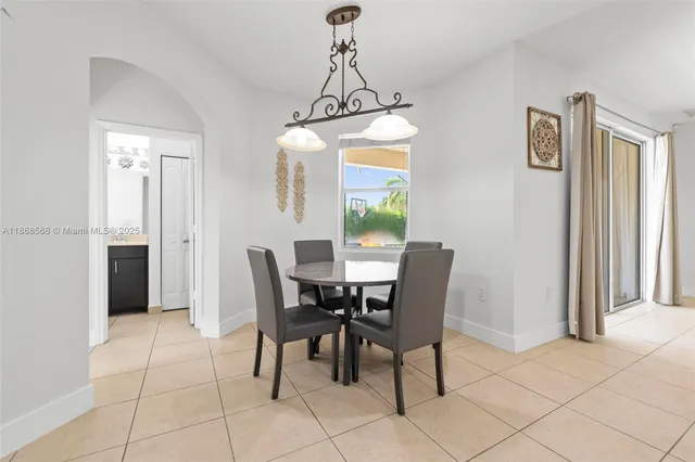 a view of a dining room with furniture and window