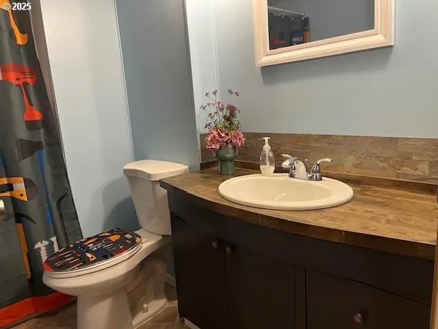 a bathroom with a sink a toilet and mirror