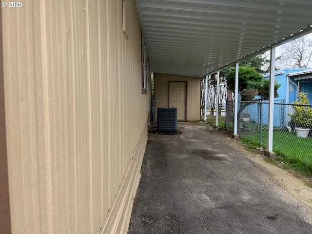 a view of a porch with furniture and wooden fence