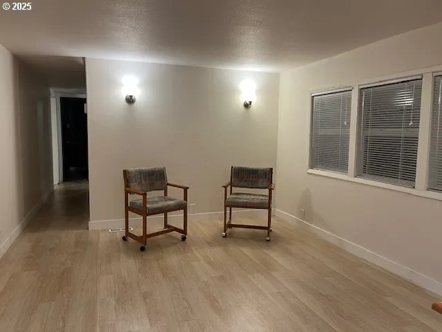 a view of a livingroom with furniture and a window