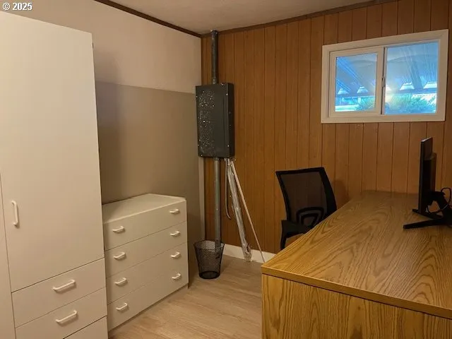 a bedroom with a bed and a flat tv screen on dresser