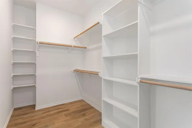 a view of walk in closet with empty racks