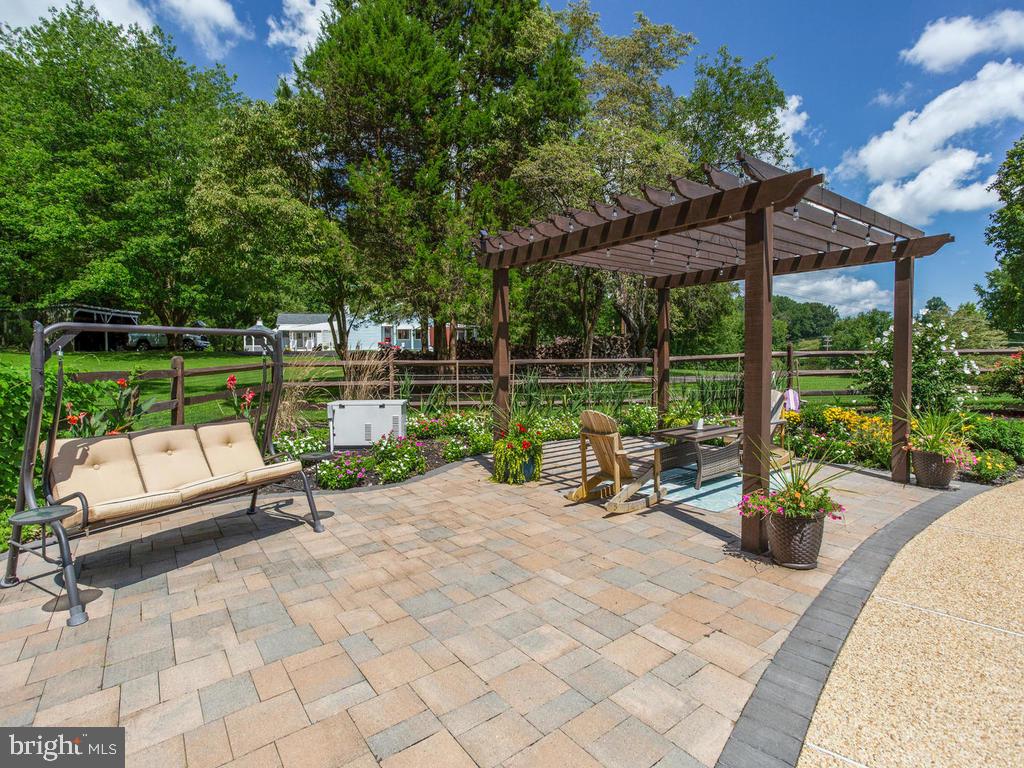 6678 Old Solomons Island Road Friendship, MD 20758 - Photo 13 of 57 a view of a patio with a table chairs and a backyard