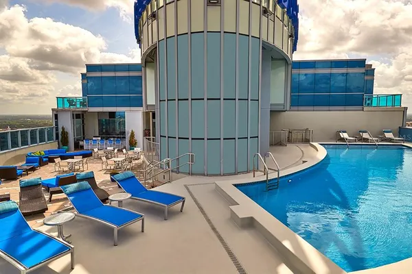 a backyard of a house with barbeque oven table and chairs