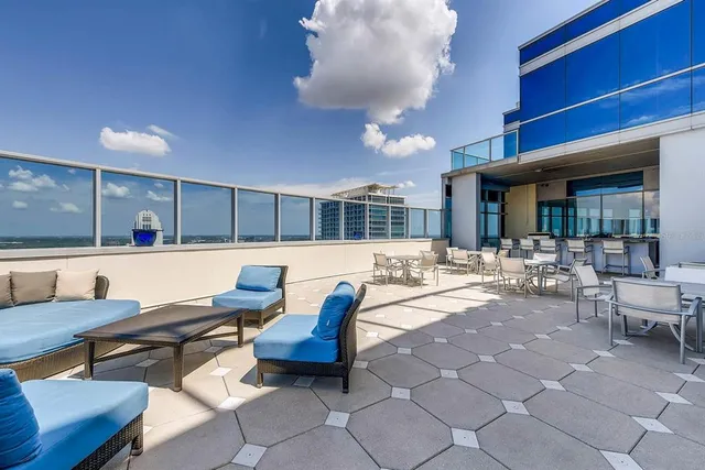 a living room with patio furniture and a potted plant