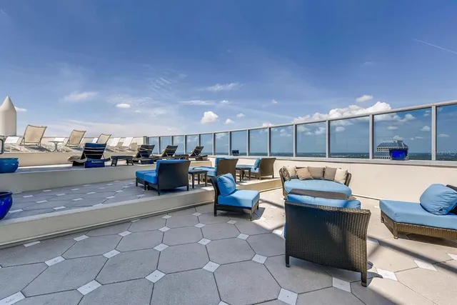 a lobby with furniture and a rug