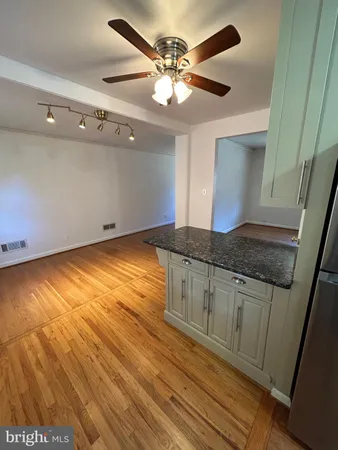 a kitchen with granite countertop a sink and cabinets