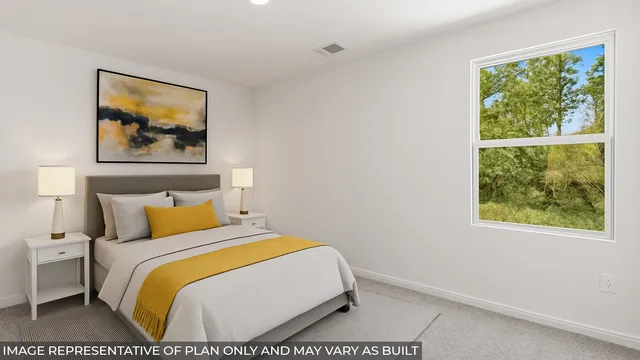 a bedroom with a bed and a painting on the wall