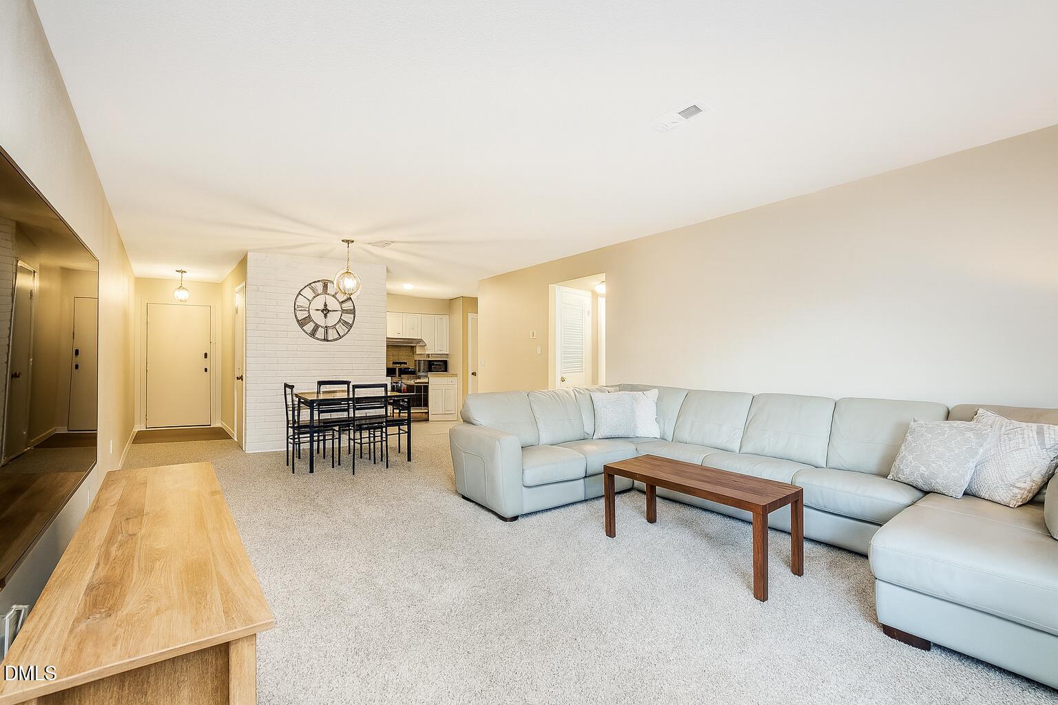 677 Pine Ridge Place, Unit 677 Raleigh, NC 27609 - Photo 3 of 7 a living room with furniture and a couch