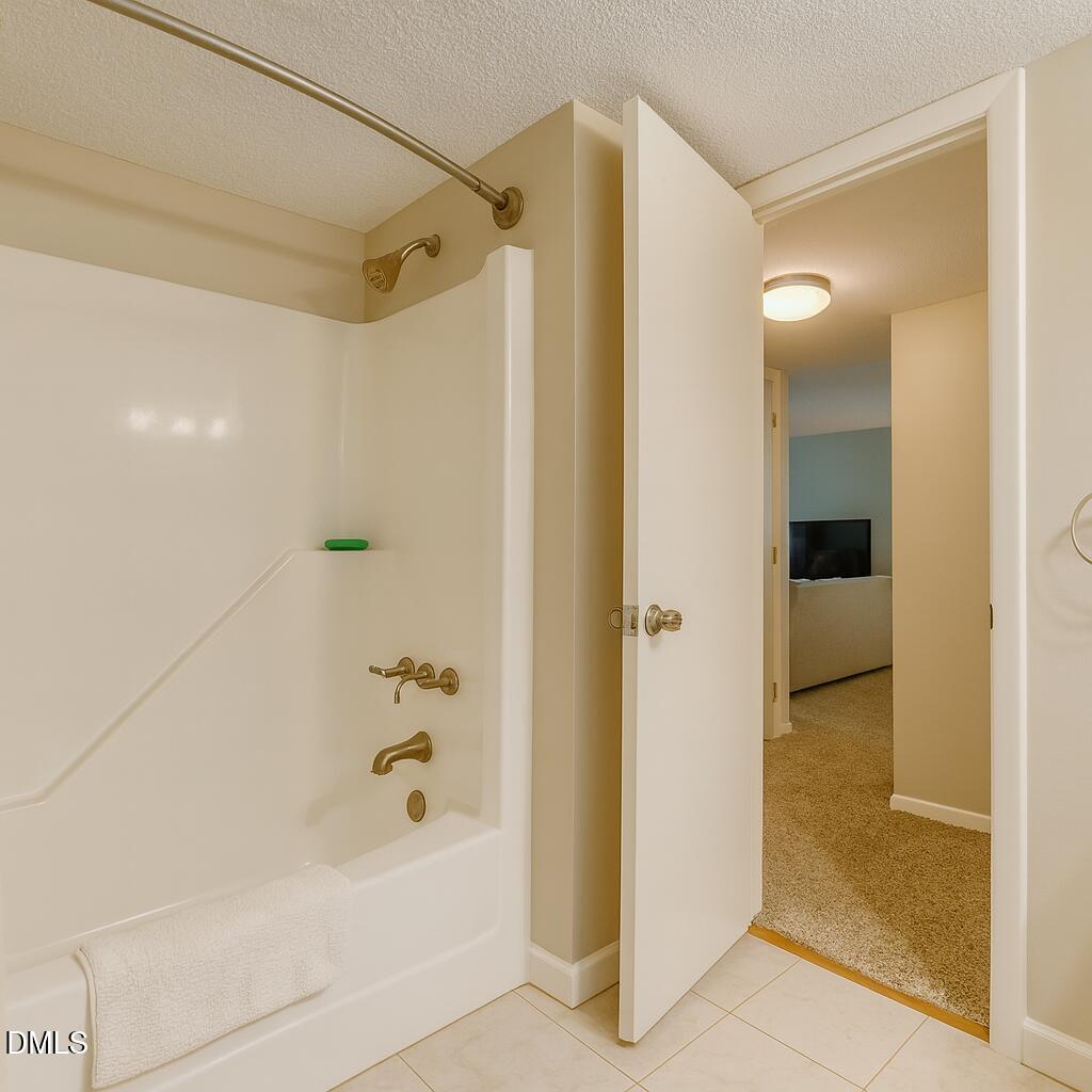 677 Pine Ridge Place, Unit 677 Raleigh, NC 27609 - Photo 5 of 7 a bathroom with a bathtub and a shower