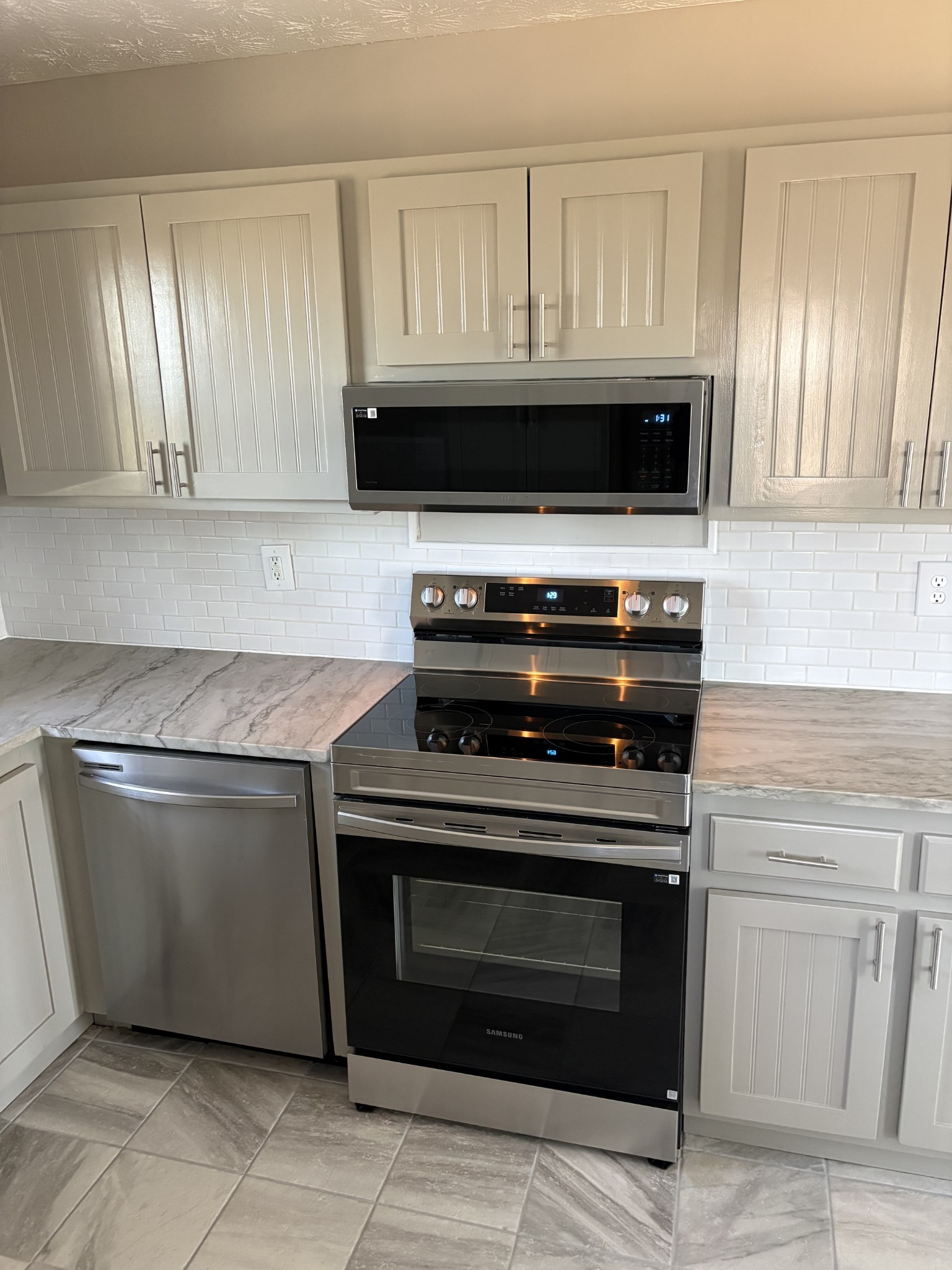 1358 Hurricane Ridge Road Smithville, TN 37166 - Photo 18 of 29 a kitchen with granite countertop a stove oven and white cabinets
