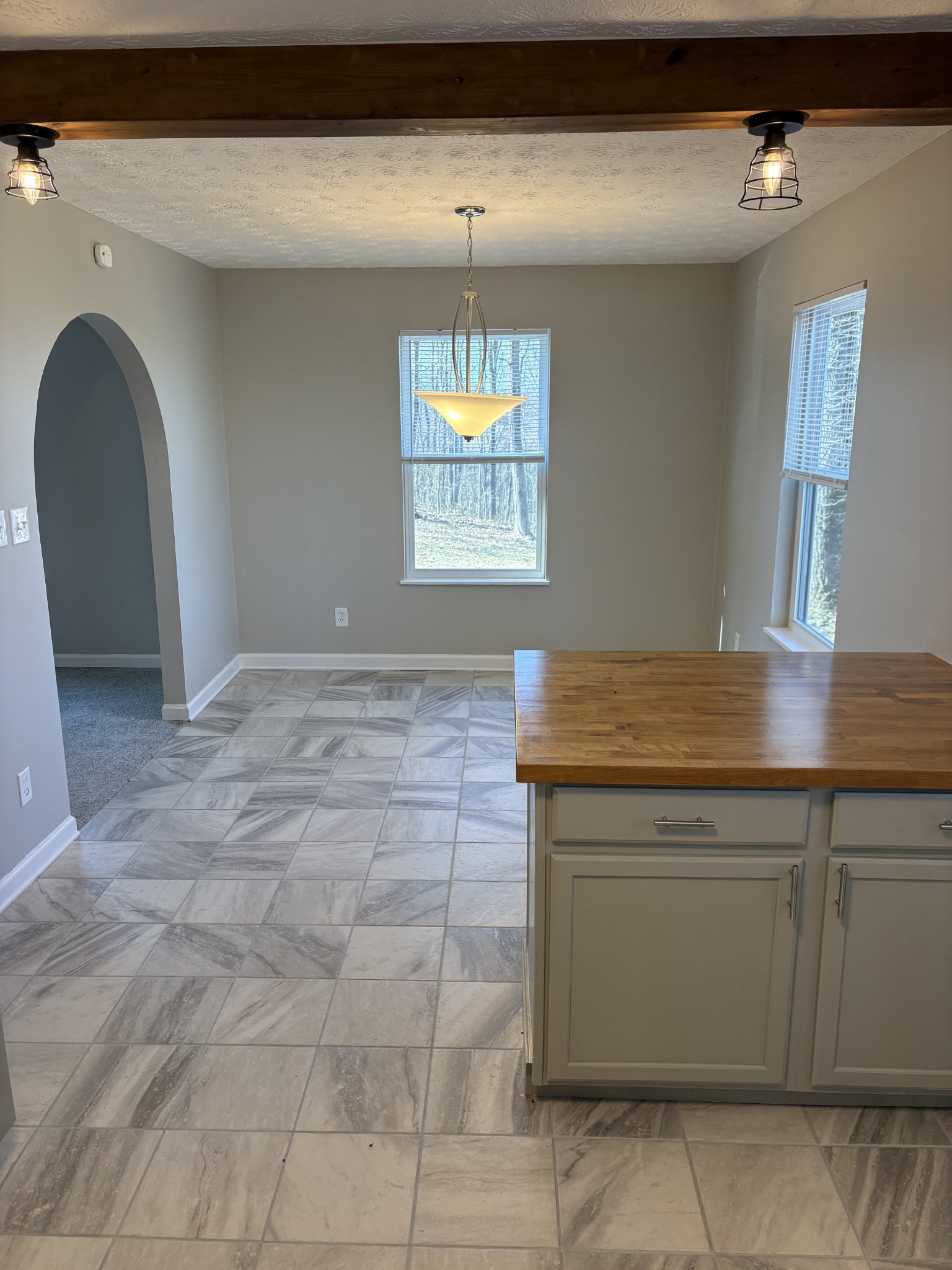 1358 Hurricane Ridge Road Smithville, TN 37166 - Photo 19 of 29 a view of entryway with kitchen island granite countertop a sink a stove a counter space and a window