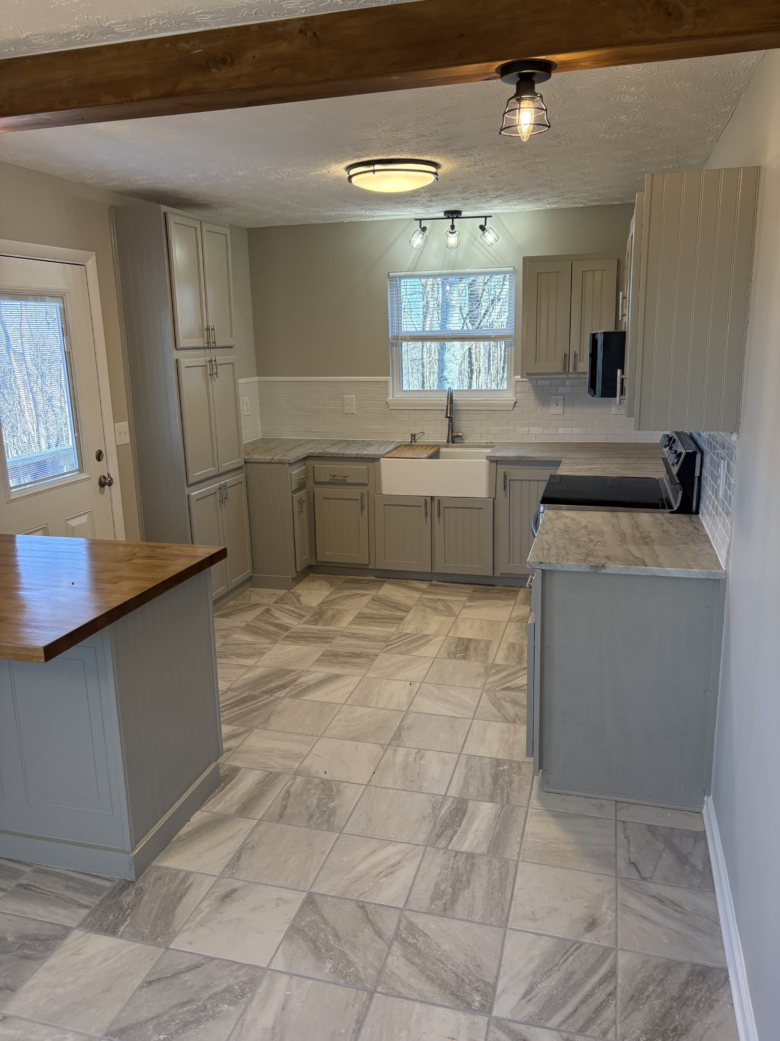 1358 Hurricane Ridge Road Smithville, TN 37166 - Photo 20 of 29 a kitchen with a stove a sink and a refrigerator