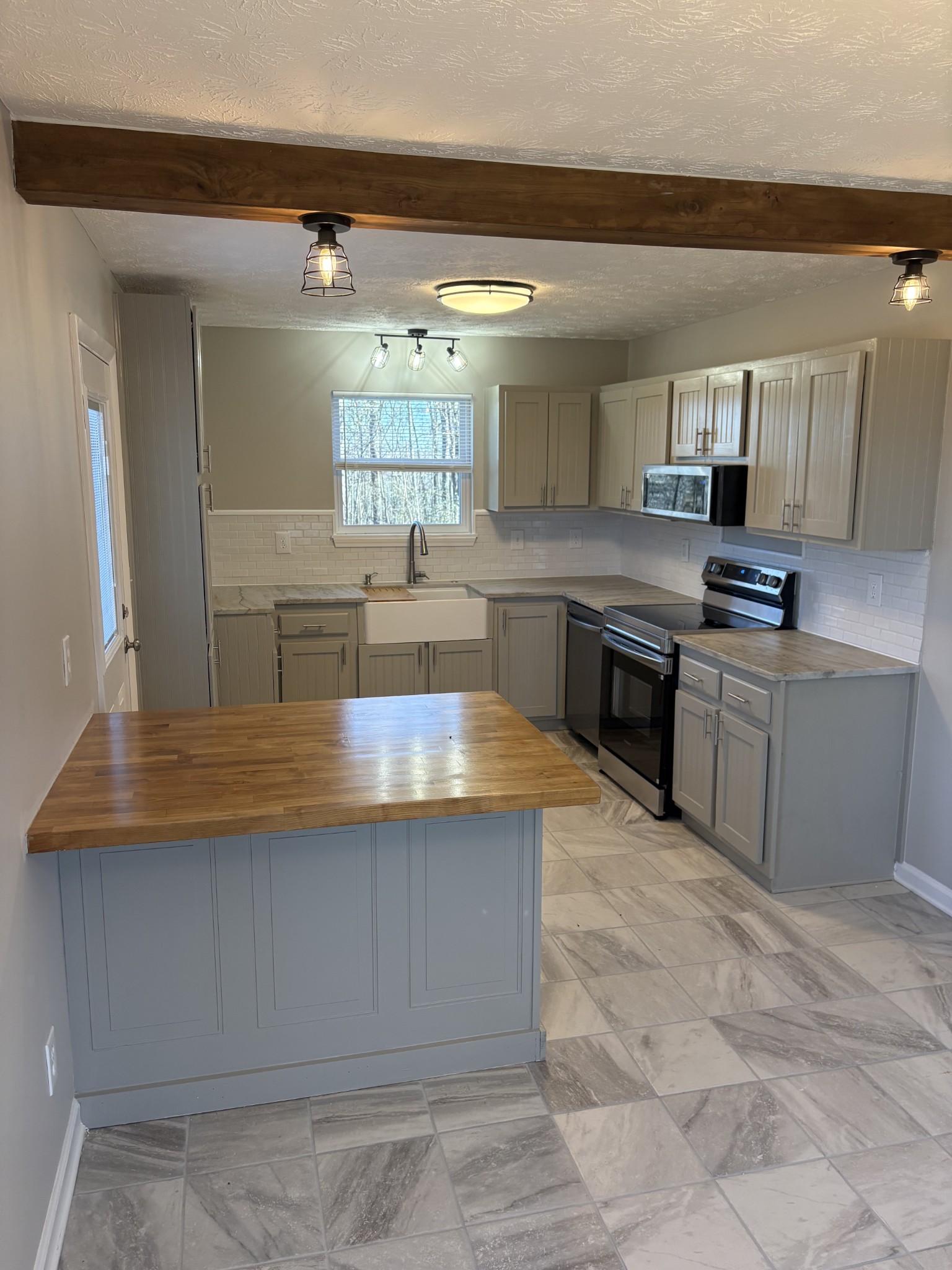 1358 Hurricane Ridge Road Smithville, TN 37166 - Photo 21 of 29 a large kitchen with kitchen island a sink counter top space and appliances