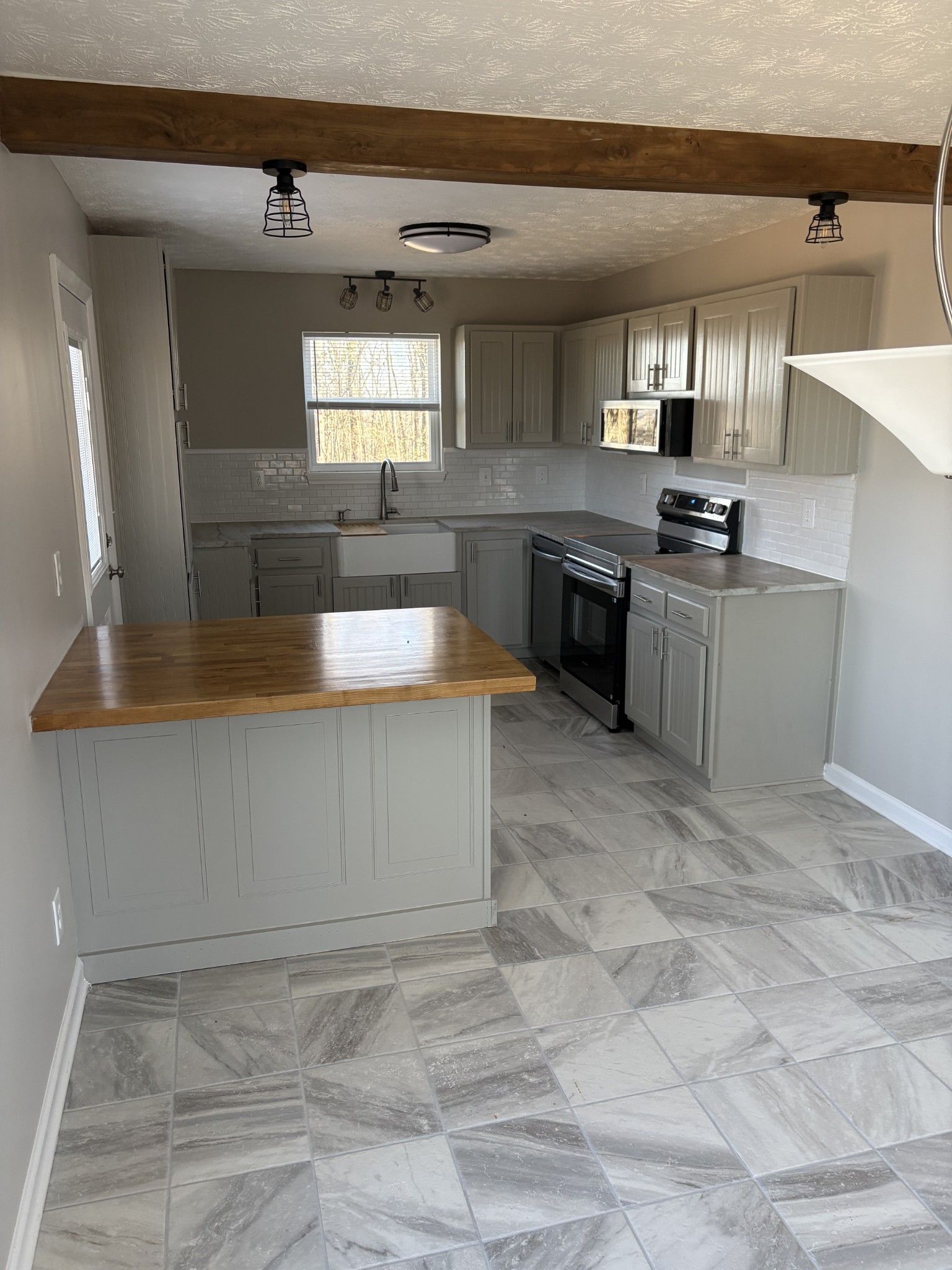 1358 Hurricane Ridge Road Smithville, TN 37166 - Photo 22 of 29 a kitchen with stainless steel appliances granite countertop a sink and a stove