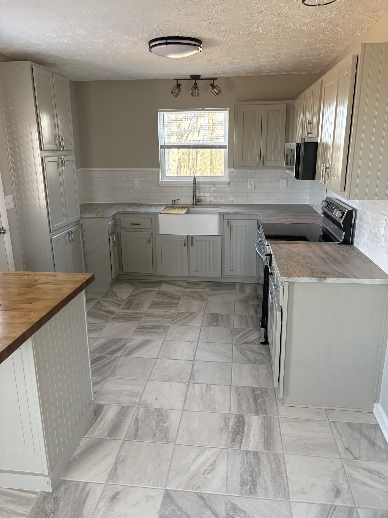 1358 Hurricane Ridge Road Smithville, TN 37166 - Photo 24 of 29 a kitchen with a sink a stove a counter top space and cabinets