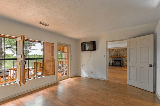 a view of a livingroom with wooden floor and a flat screen tv