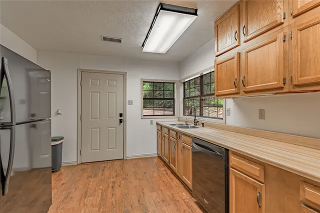 a kitchen with stainless steel appliances granite countertop a stove and a refrigerator