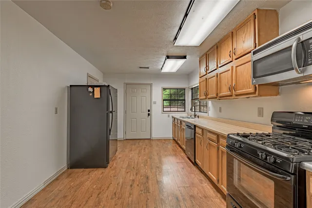 a kitchen with a sink and large window