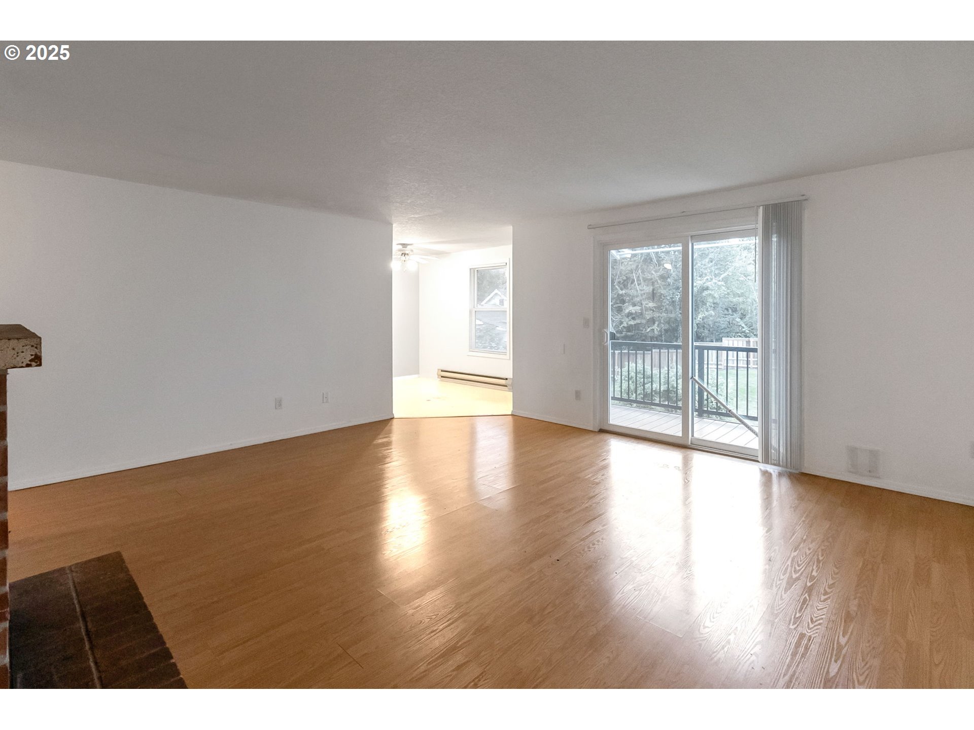 8524 Southwest Mohawk Street Tualatin, OR 97062 - Photo 4 of 30 a view of an empty room with wooden floor and a window