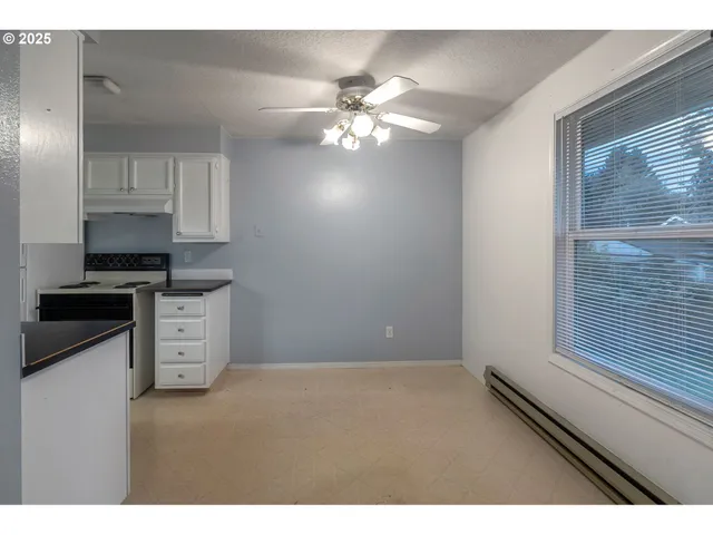 a kitchen with stainless steel appliances cabinets a window and a sink
