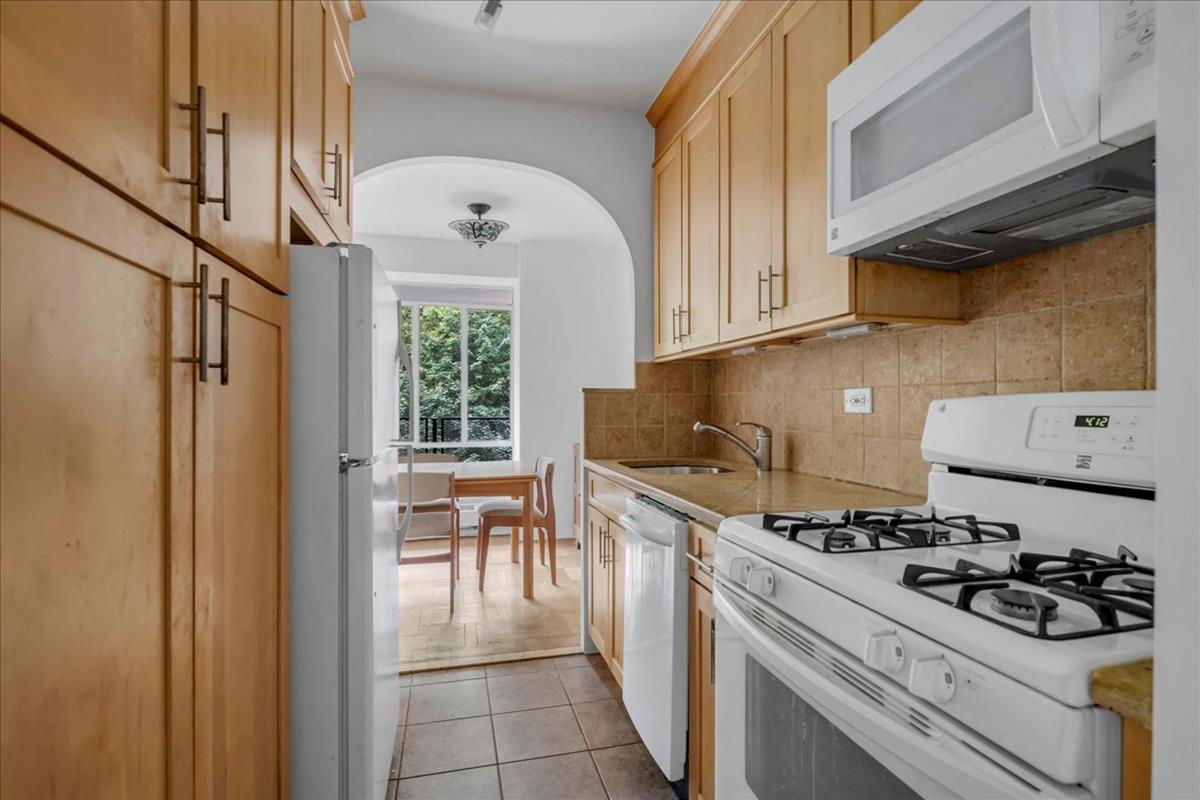 2727 Palisade Avenue, Unit 7B Bronx, NY 10463 - Photo 6 of 22 a kitchen with a stove and white cabinets