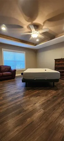 a view of a room with wooden floor and fan