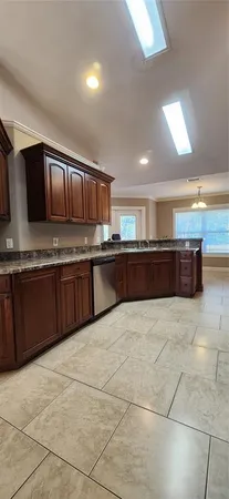a view of a kitchen with furniture and wooden cabinets