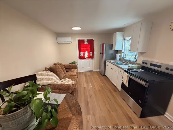 a living room with furniture and a potted plant