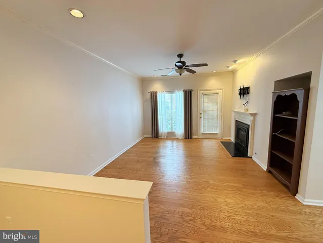 a view of an empty room with a fireplace and a window