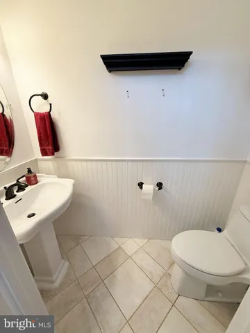 a bathroom with a sink mirror and toilet